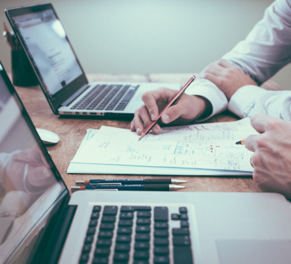people at desk with laptops